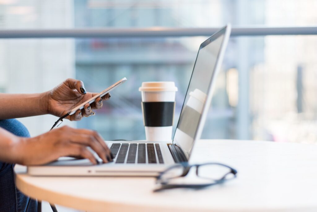 A person using AI to start a side hustle, sitting at a desk and working on a computer